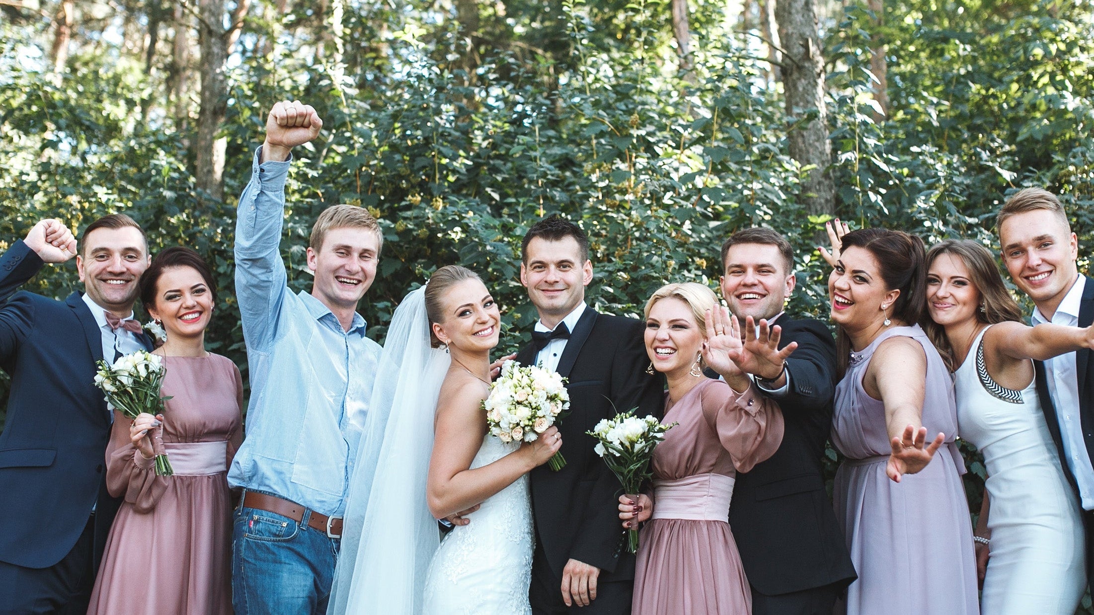 Newlyweds with friends posing in park