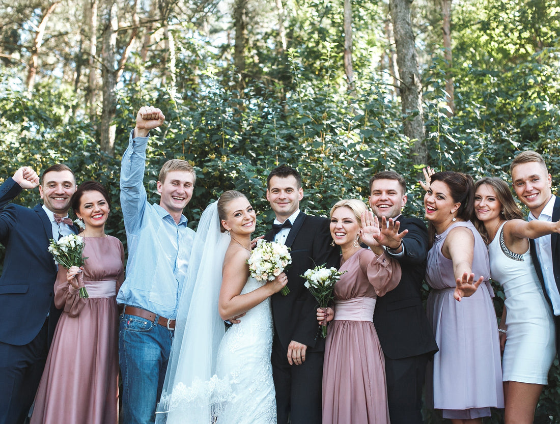 Newlyweds with friends posing in park