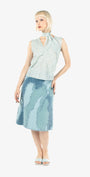 Woman wearing a light blue sleeveless top and skirt on a white background