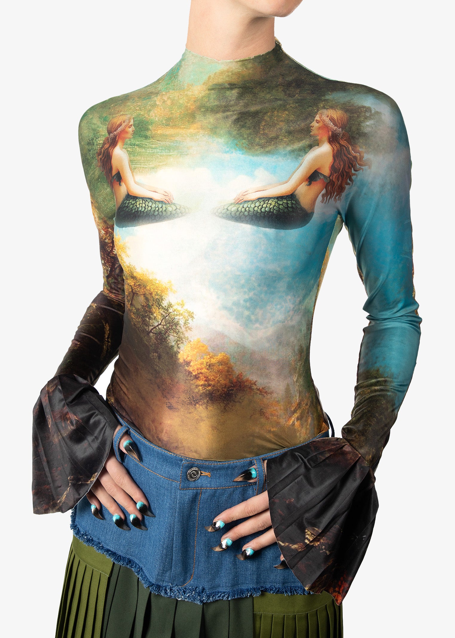 Long-sleeve top with artistic design of a woman in nature, paired with a denim skirt.