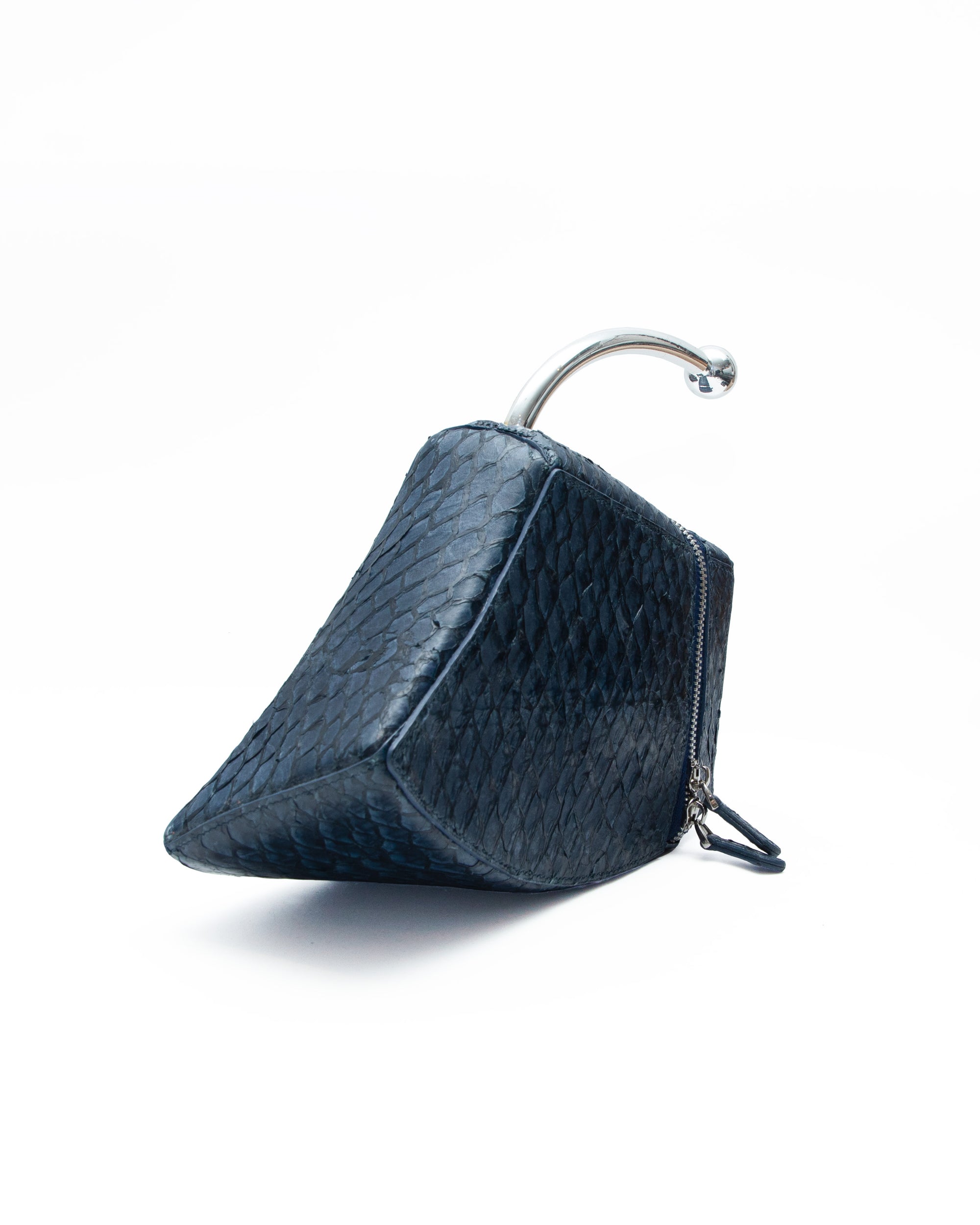 Blue textured wedge-shaped pillow with a zipper on a white background