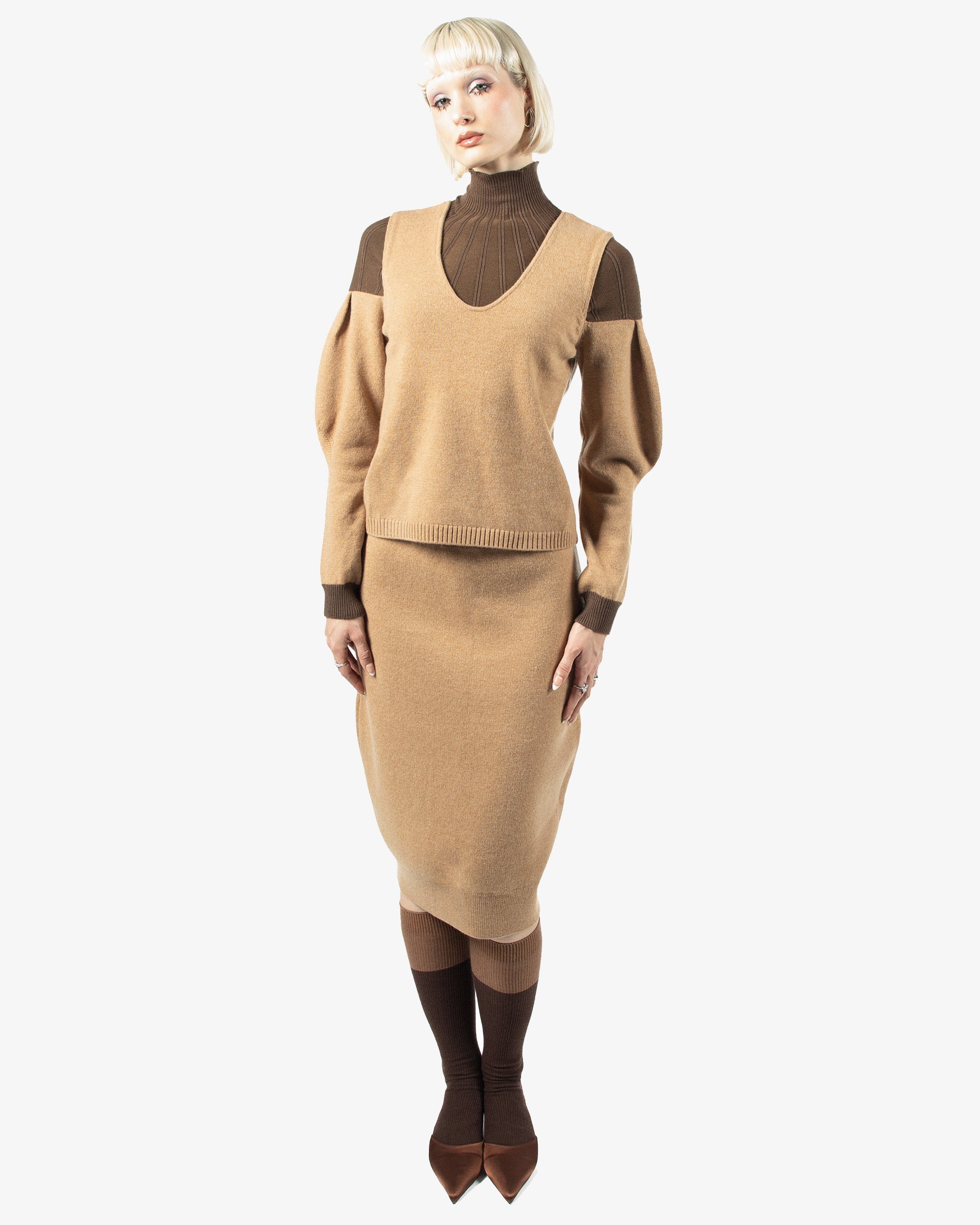 Woman wearing riverpeace sweater and skirt