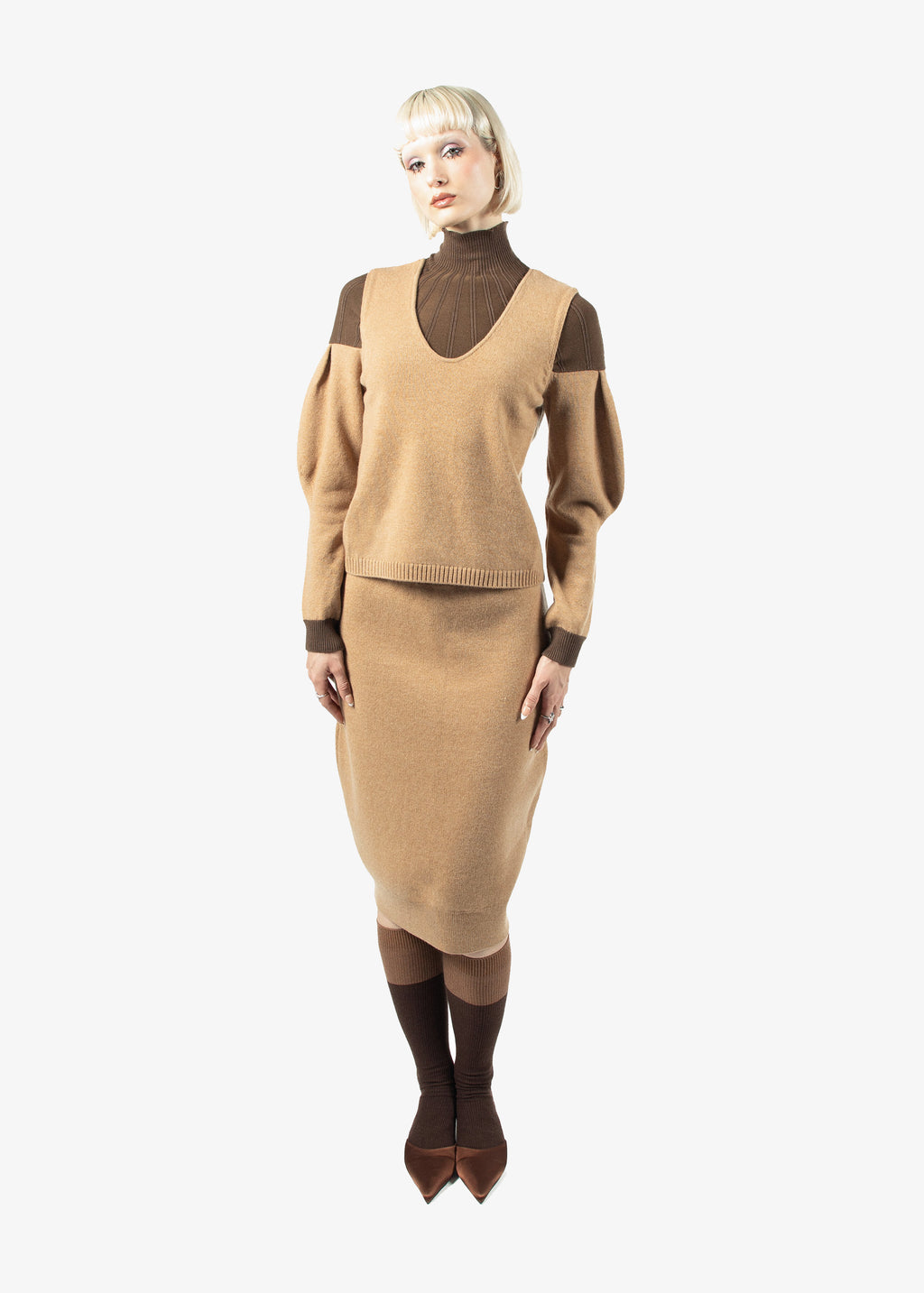 Woman wearing riverpeace sweater and skirt