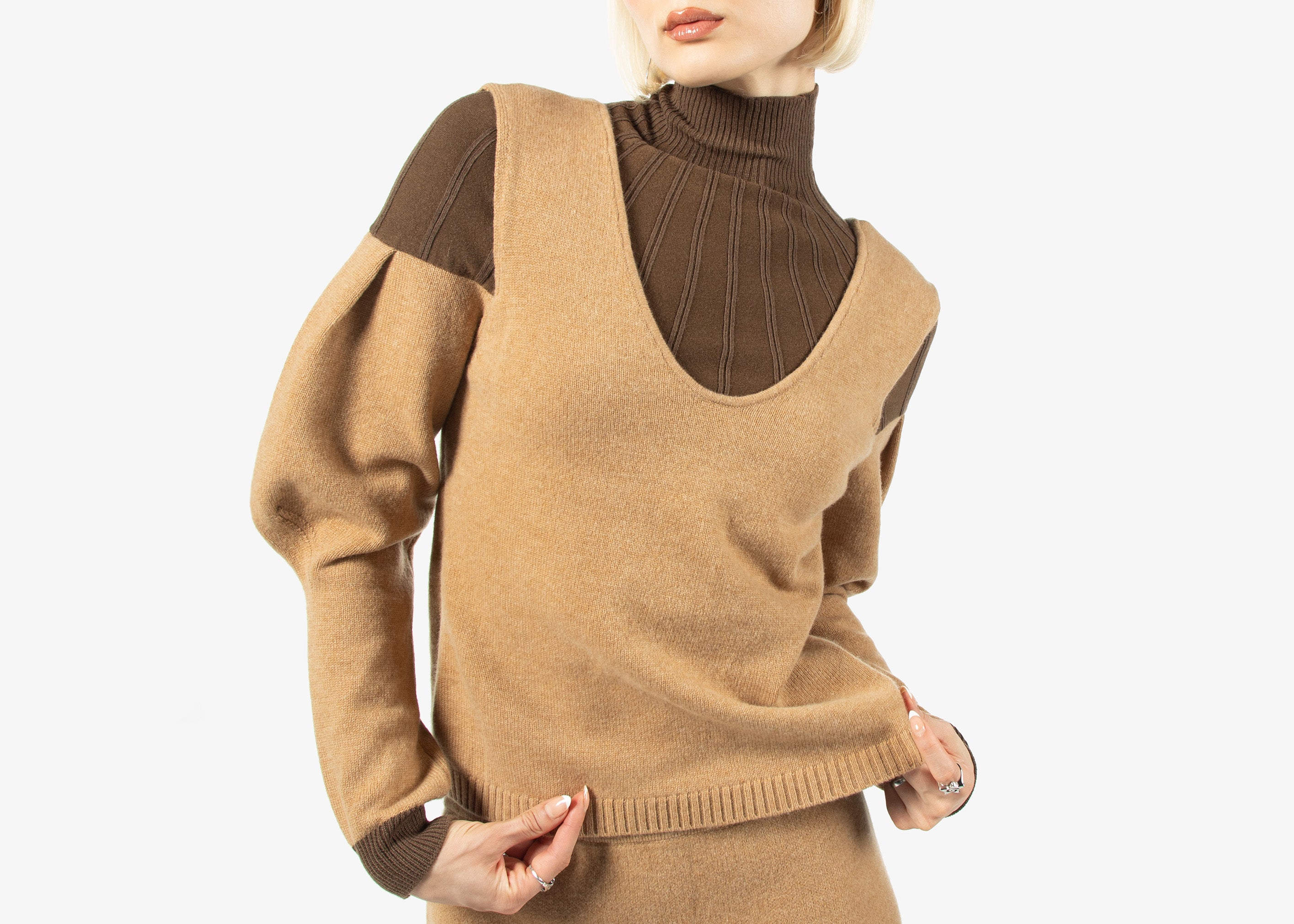 Woman wearing a brown sweater dress with a white background